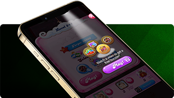 Smartphone mit Candy Crush und einer Belohnung für das Ansehen eines Videos vor grün gestreiftem Hintergrund.