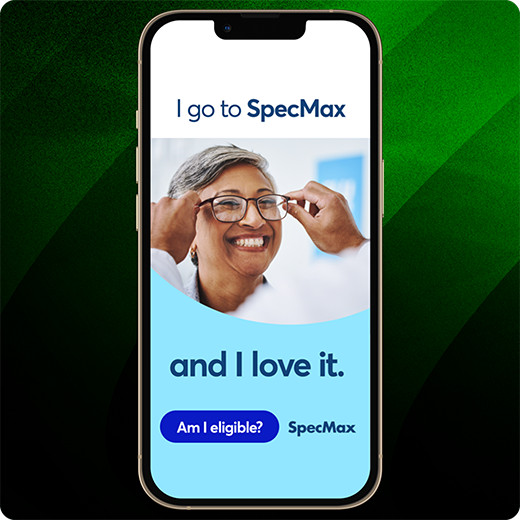 Smartphone displaying a SpecMax ad with the text “I go to SpecMax and I love it” and a blue button labeled “Am I eligible?” at the bottom, set against a green striped background.