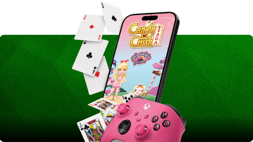 Smartphone displaying the Candy Crush Saga game screen with a character illustration, surrounded by floating playing cards, and a pink Xbox controller in the foreground, all set against a green striped background.