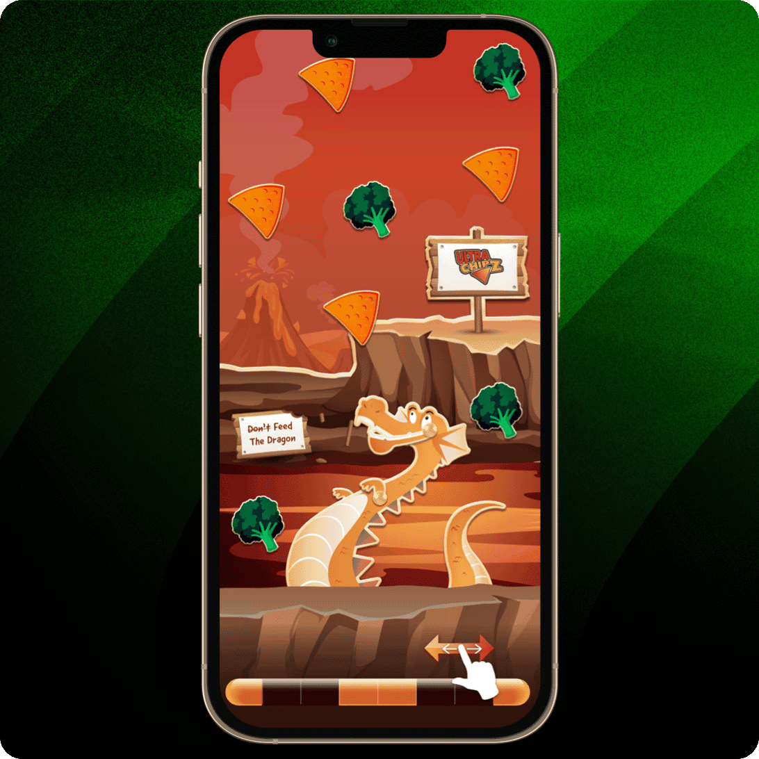 Smartphone displaying a game screen with an orange dragon in a rocky canyon environment, surrounded by falling triangular chips and broccoli pieces, with signs reading “Don’t Feed The Dragon” and “Cheese Craze,” plus a swipe arrow at the bottom. 