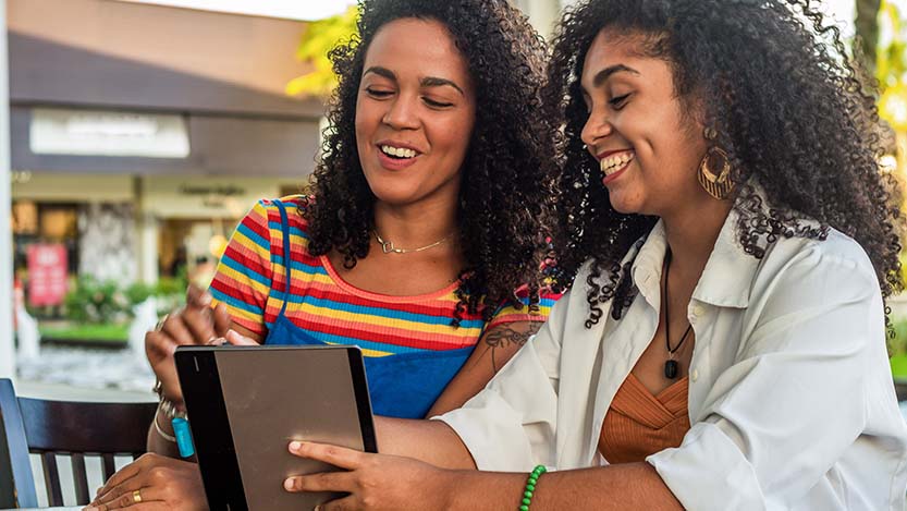 Two people looking at a tablet.