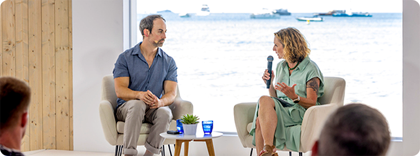 Jonathan Stringfield and Lynne Kjolso, VP of Global Partner and Retail Media at Microsoft, discuss gaming on Microsoft Beach at Cannes Lions 2024.