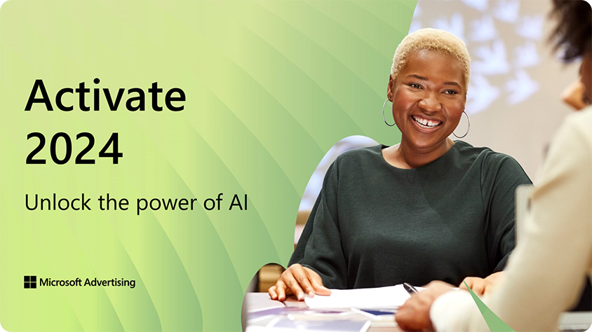 A person sitting at a desk smiling at the camera.